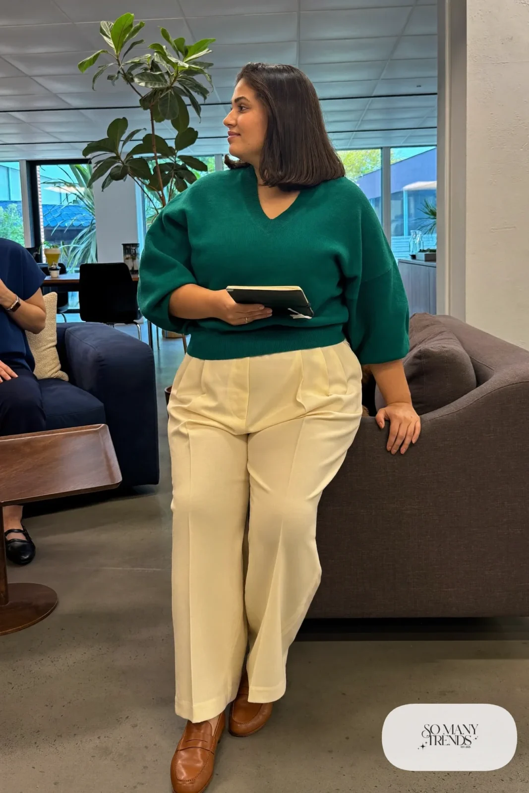 Woman in deep teal V-neck sweater, cream crepe wide-leg pants and cognac loafers, outfit 14