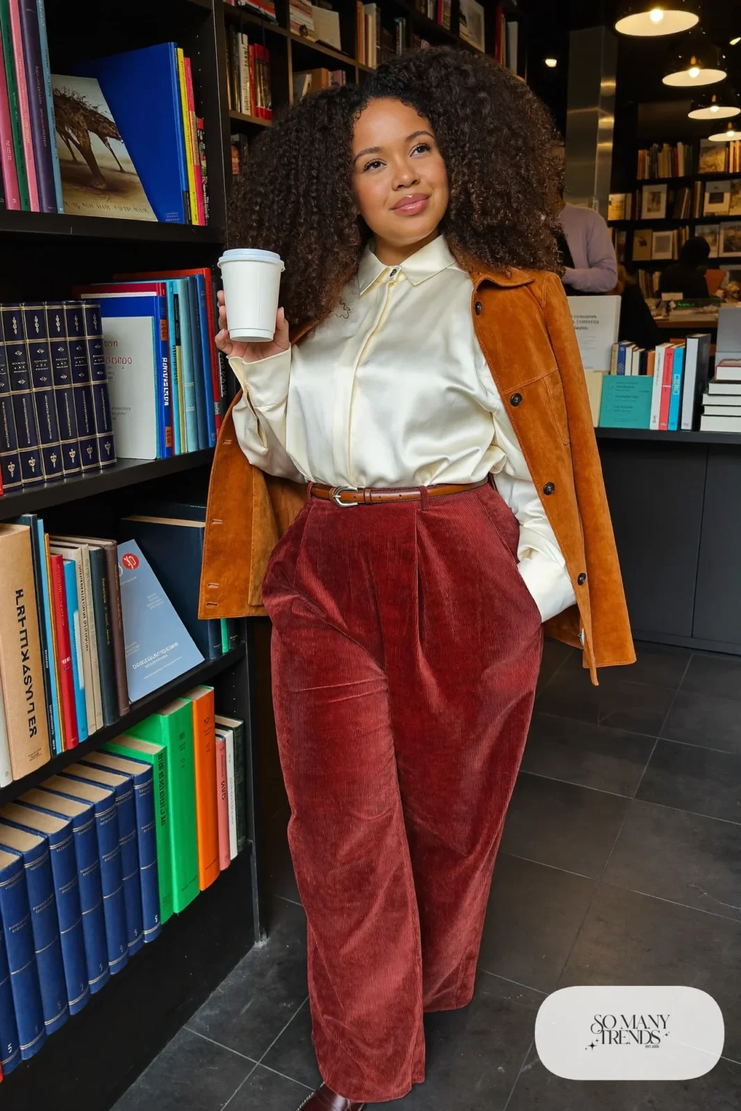 Plus size woman in brown corduroy pants, ivory blouse, belt and cognac suede jacket, outfit 27