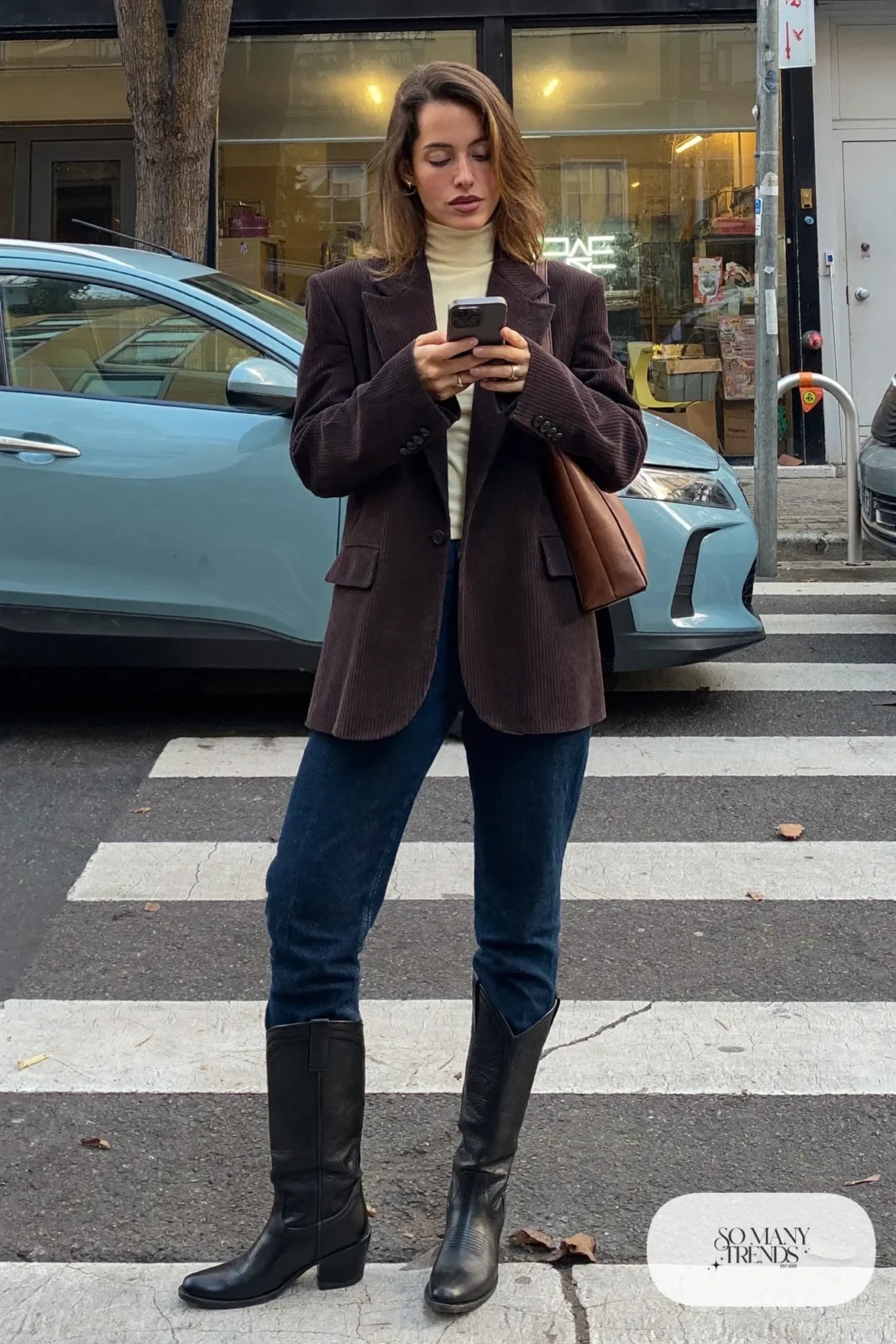 Brown corduroy blazer, cream turtleneck, straight dark jeans and black cowboy boots, outfit 2
