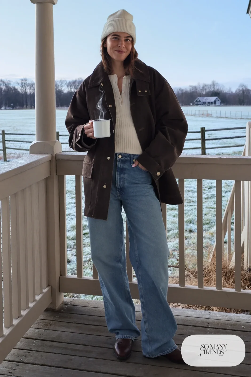 Chocolate waxed canvas barn jacket, cream thermal henley, wide jeans, cream beanie and brown cowboy boots, outfit 14