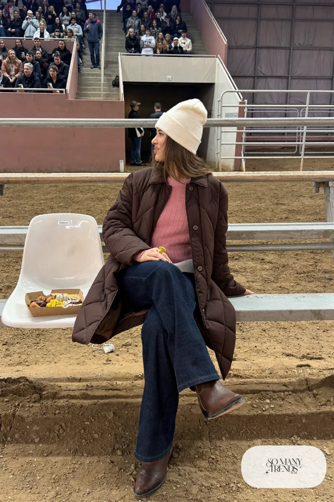 Knee-length chocolate quilted coat with western yoke over rose knit sweater with dark jeans and cowboy boots, outfit 9
