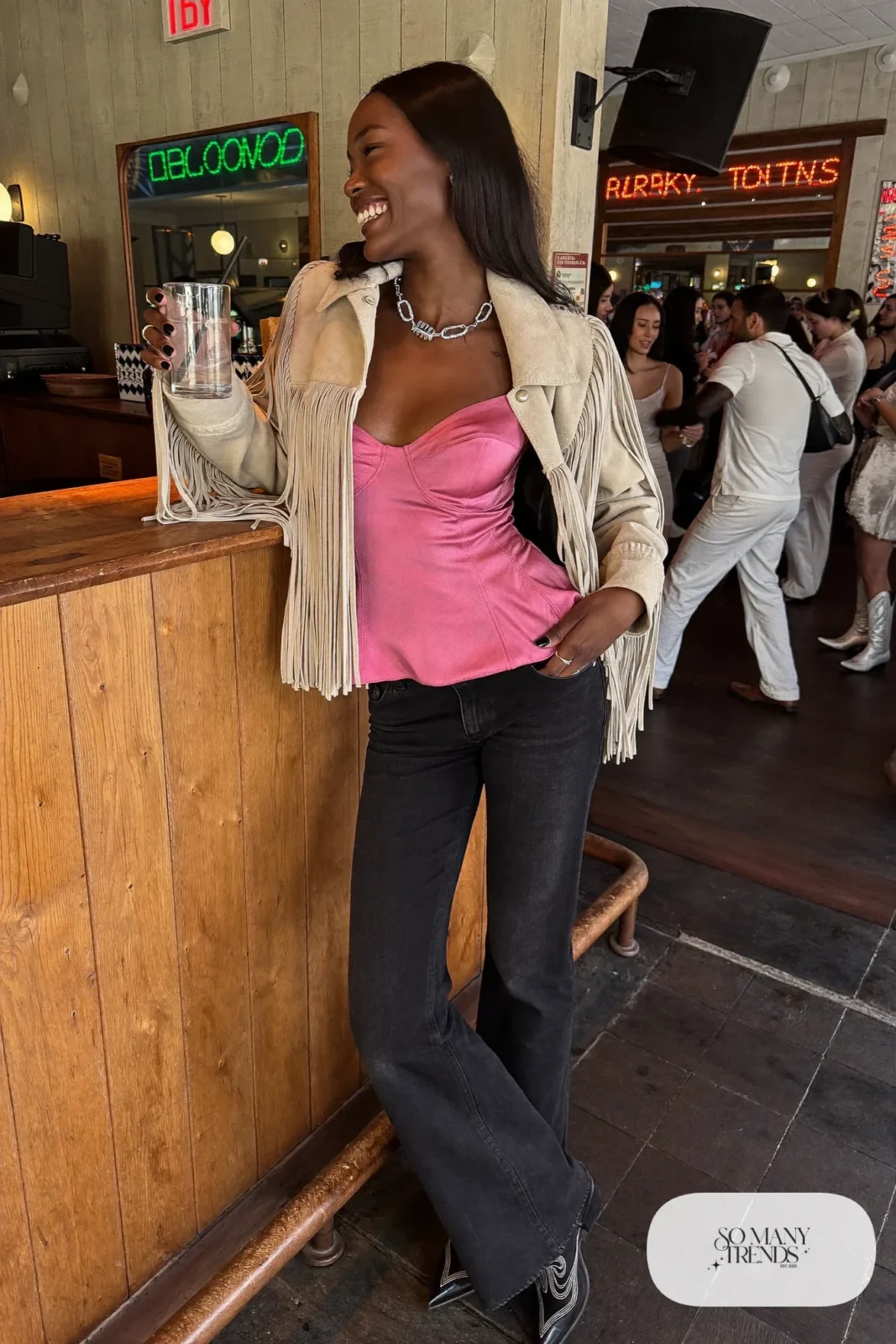 Cropped cream fringe suede jacket over rose satin cami with black flared jeans and black cowboy boots, outfit 14