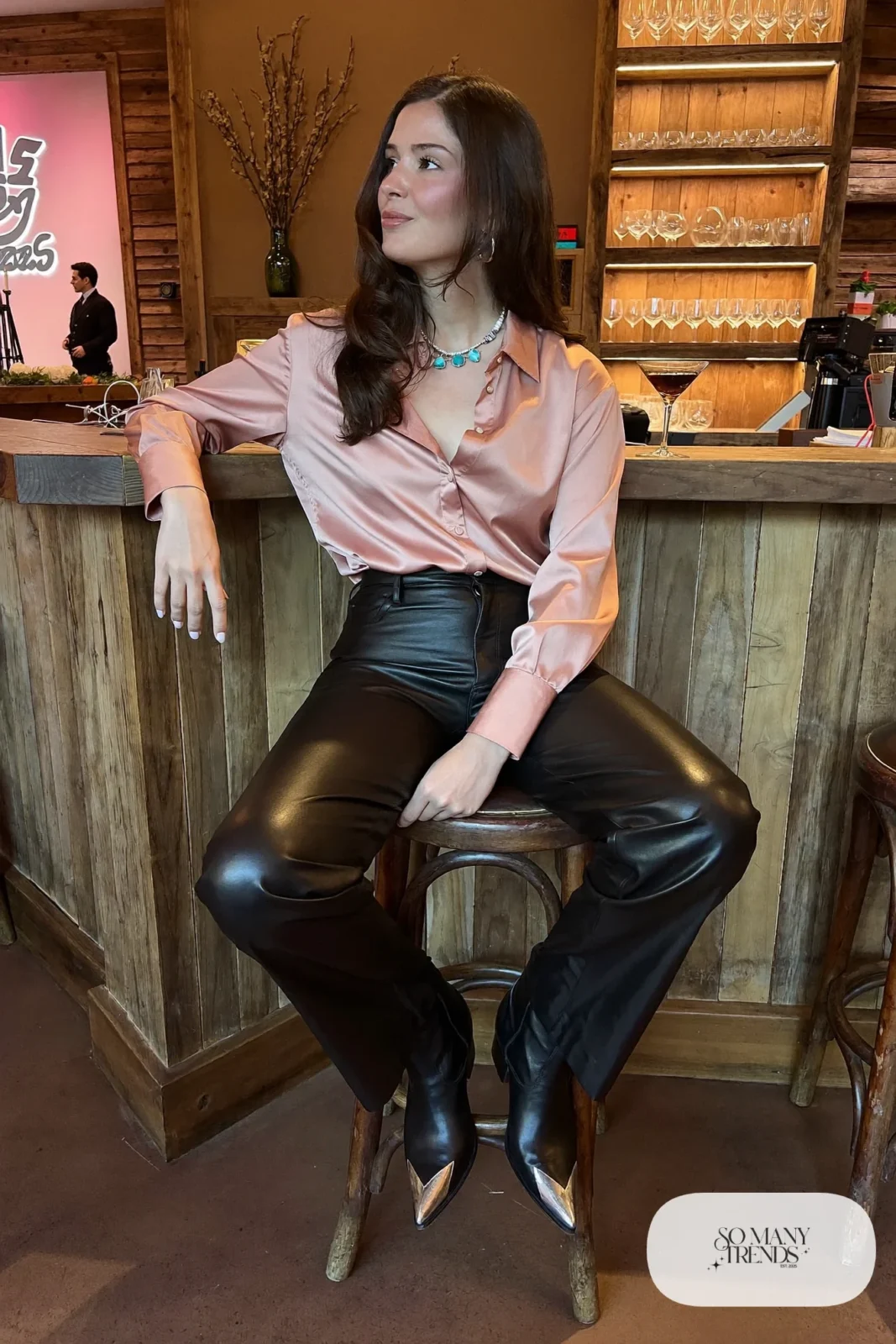Rose satin button-up shirt with black faux leather straight pants and black pointed cowboy boots, outfit 17