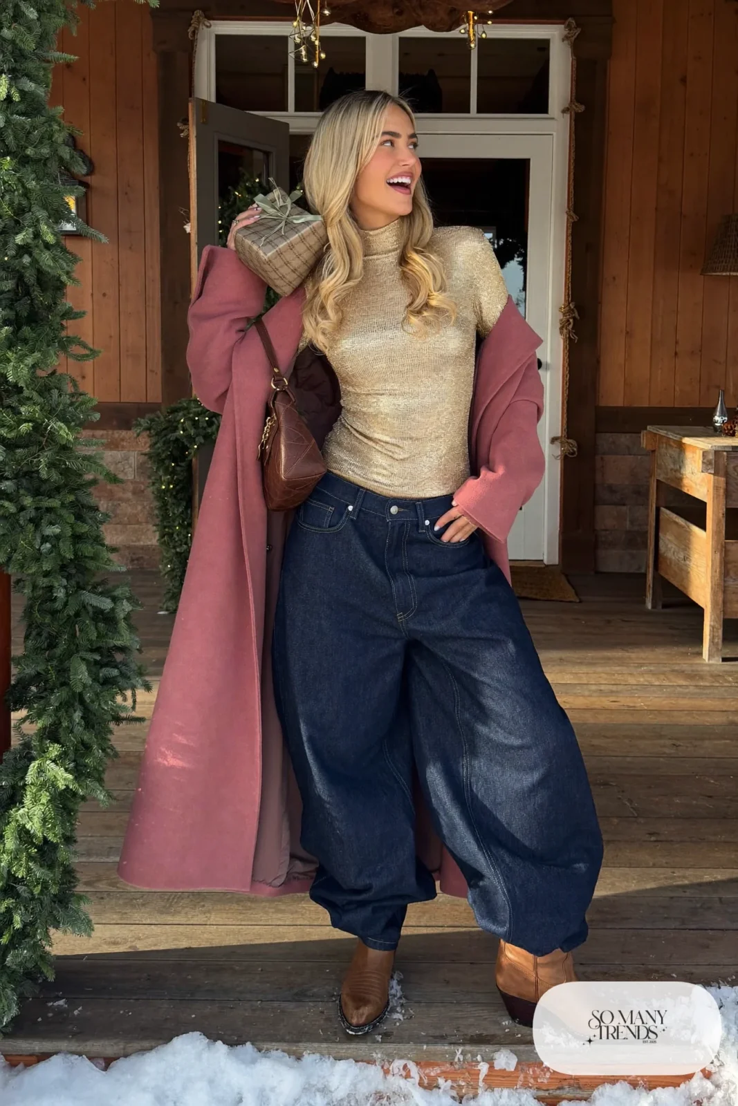 Gold lame high-neck top with wide dark jeans, rose wool coat and tan cowboy boots, outfit 22