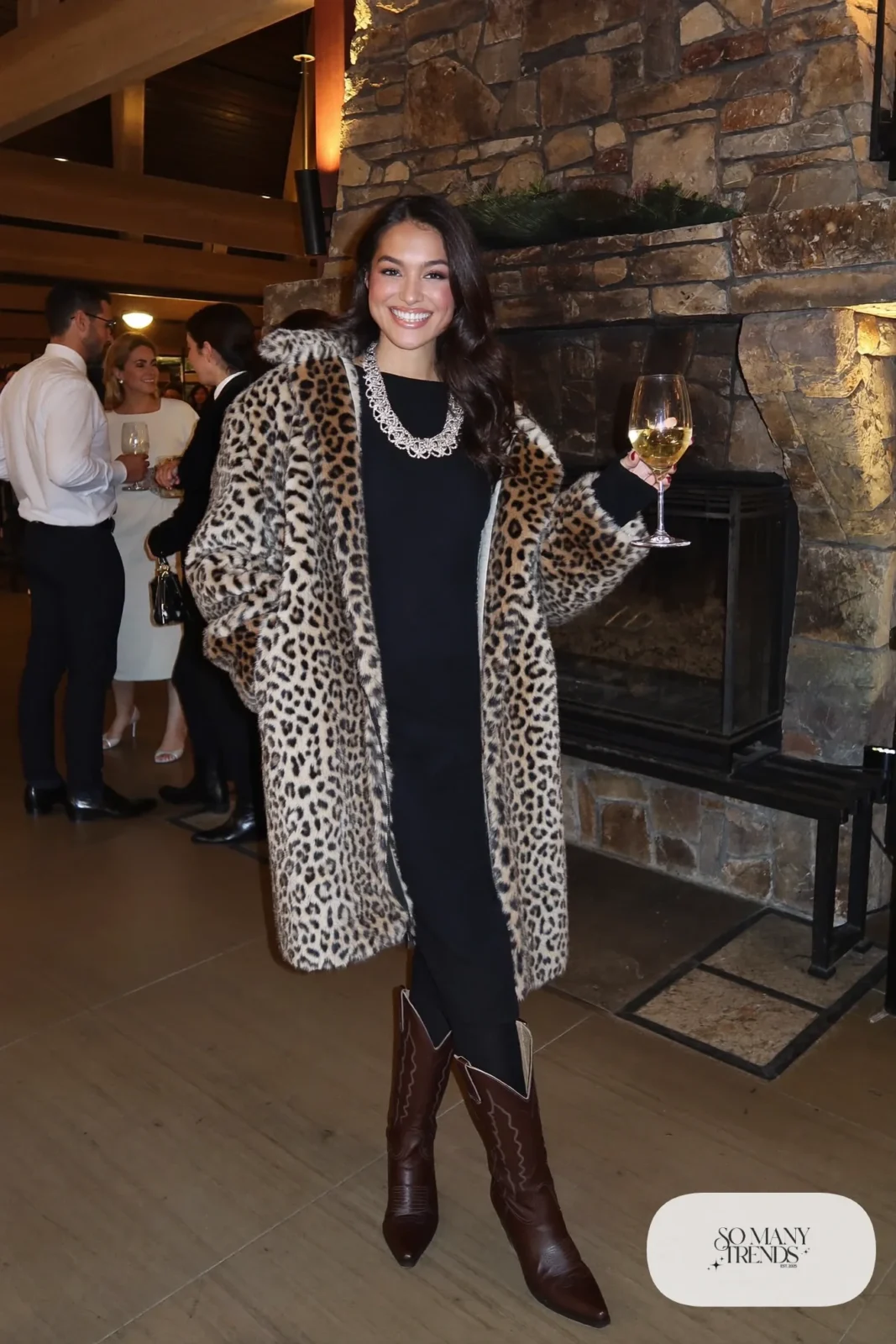 Leopard faux fur long coat over black long-sleeve midi dress with black tights and tall brown boots, outfit 23