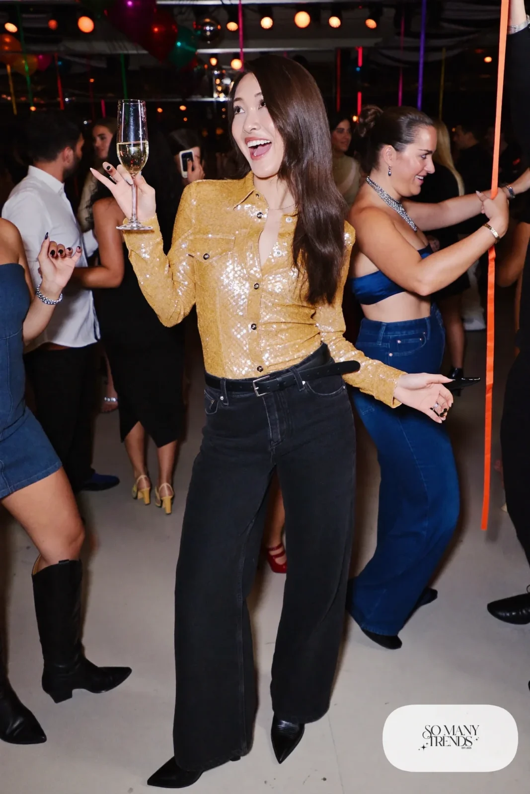 Gold sequin western snap shirt tucked into black wide-leg jeans with black pointed boots and belt, outfit 26