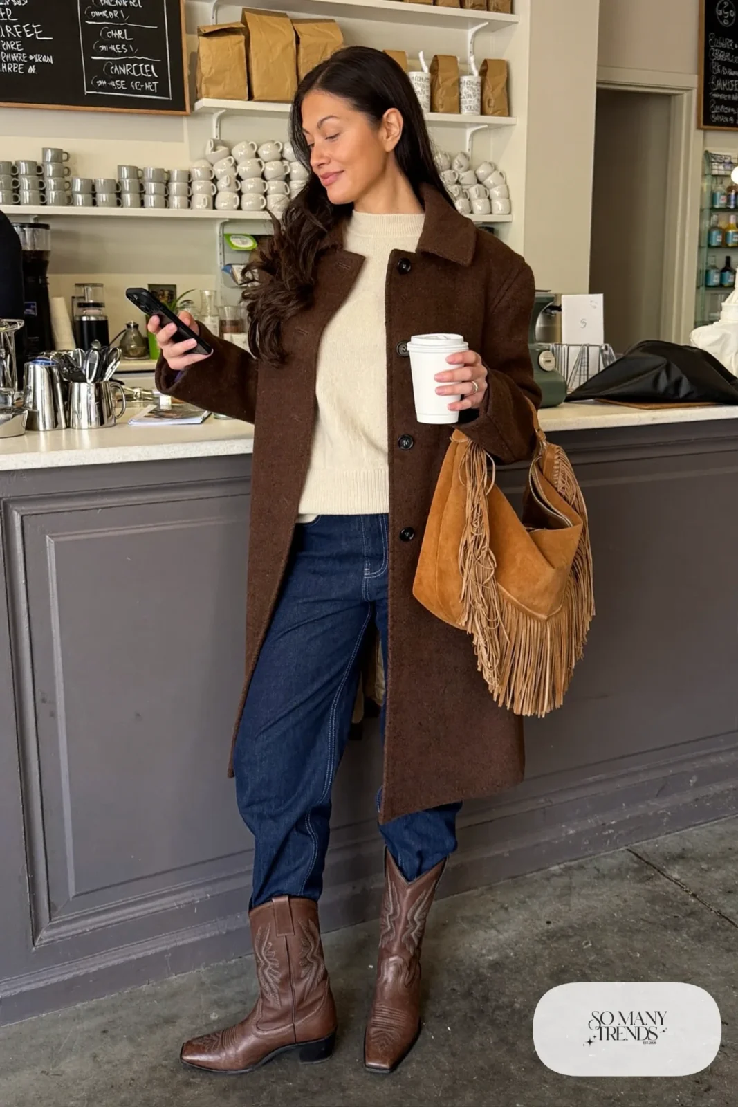 Chocolate wool coat with fringe suede shoulder bag, cream sweater, dark jeans and brown cowboy boots, outfit 30