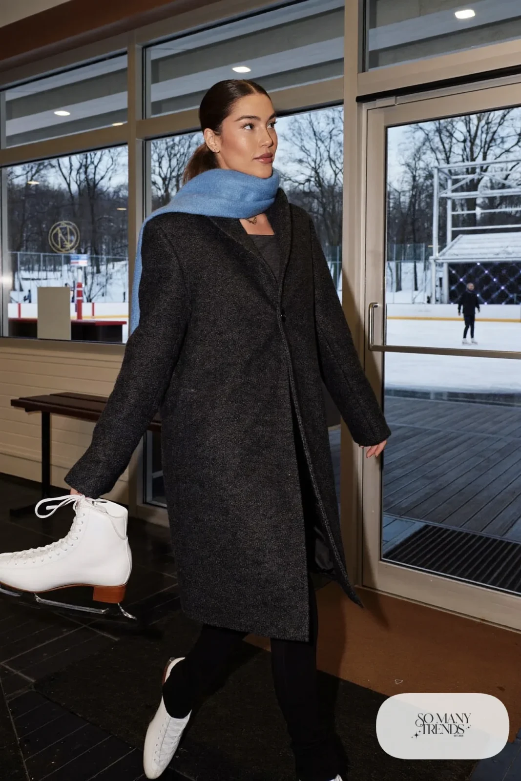 Charcoal knee-length wool coat with sky blue scarf, black stretch pants and white ice skates - outfit 7