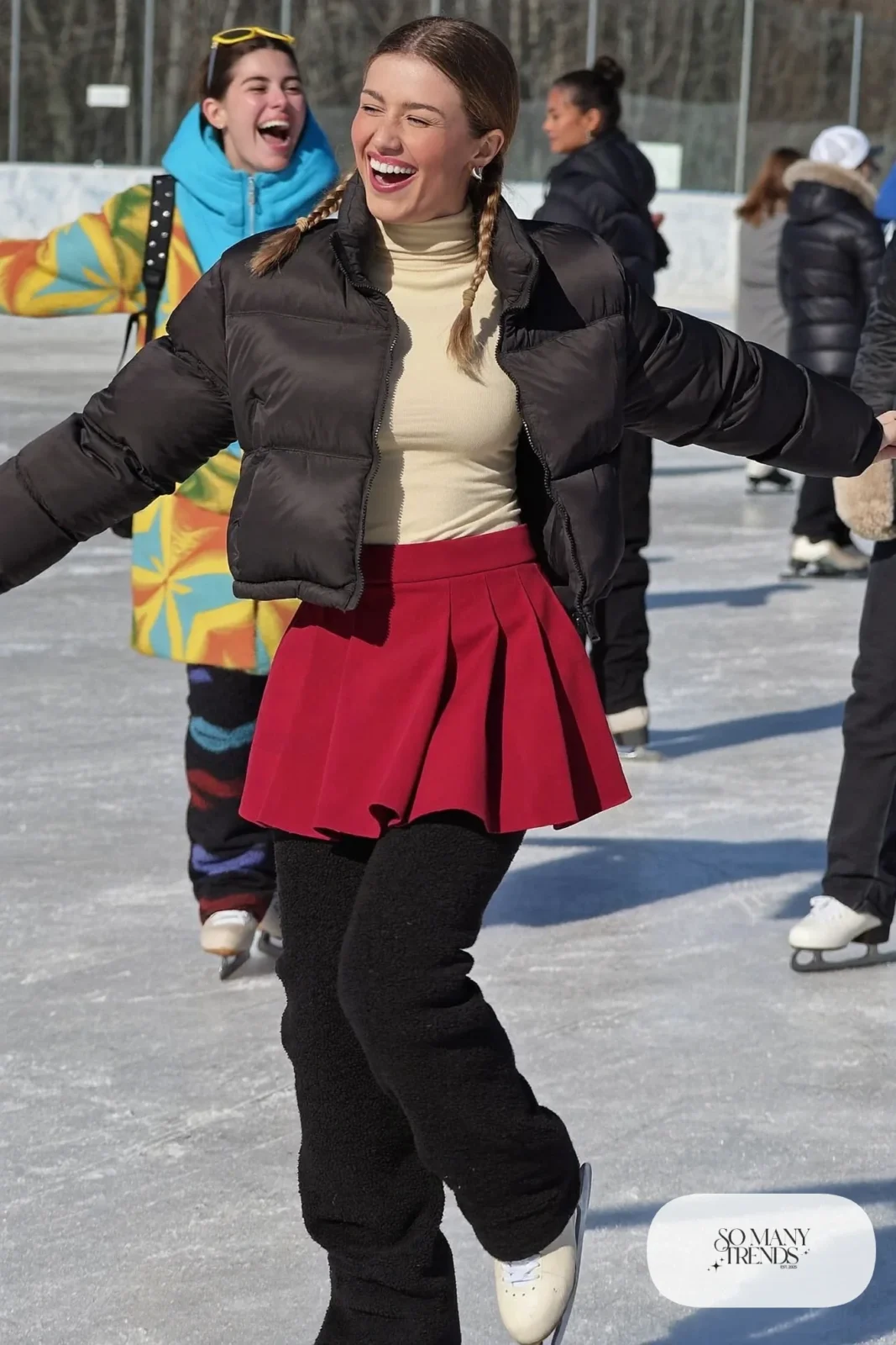 Cranberry pleated mini skirt over black fleece tights, cream turtleneck, short black puffer jacket and ice skates - outfit 9