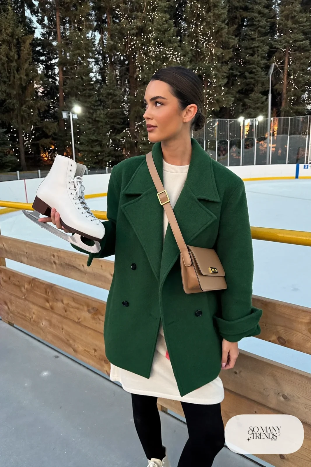 Forest green double-breasted wool coat over cream knit dress, black fleece tights, mocha crossbody and ice skates - outfit 20