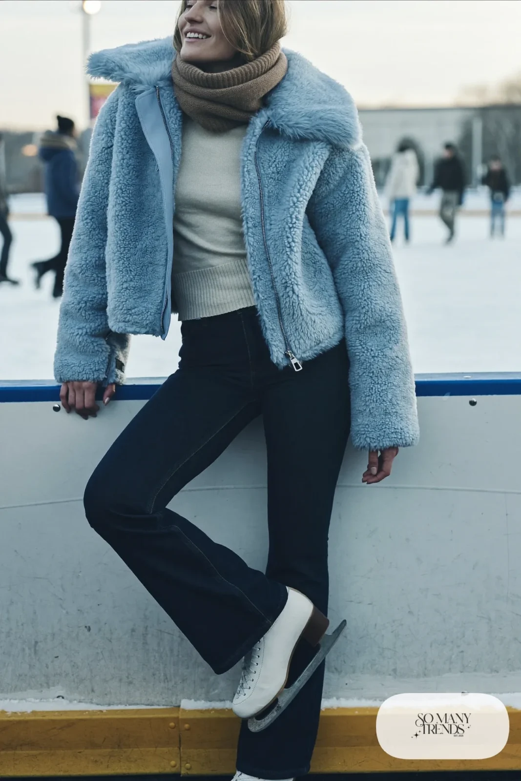 Sky blue cropped faux shearling jacket over cream turtleneck, dark stretch straight jeans, mocha scarf and ice skates - outfit 24