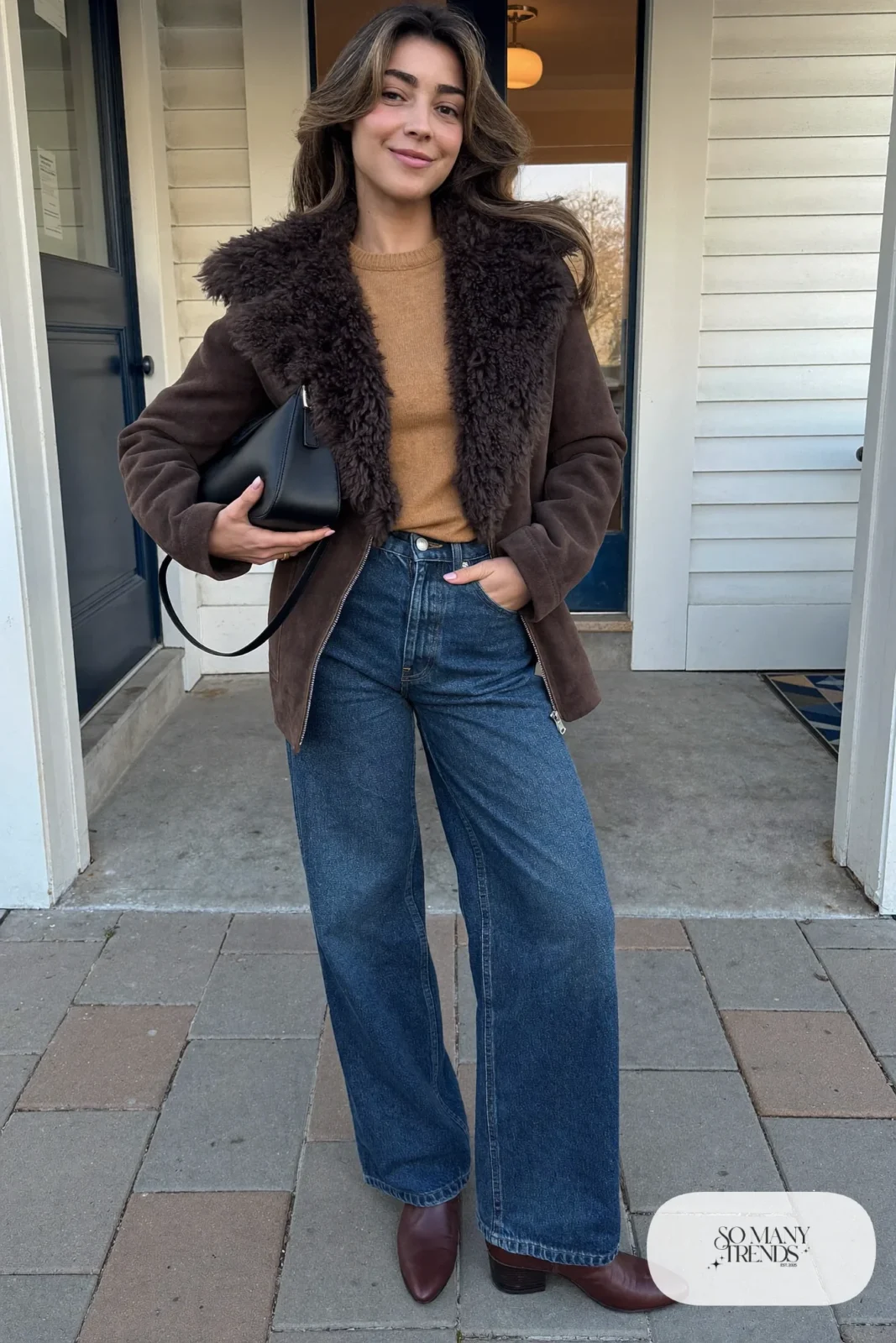 Brown cropped faux-shearling jacket, mustard sweater, wide mid-blue jeans and brown boots - outfit 27