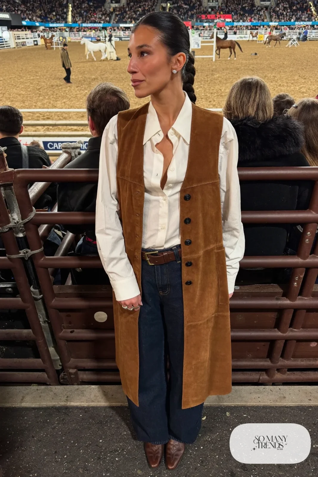 Woman in camel suede vest, white shirt, dark straight jeans and brown boots, NFR outfit 16