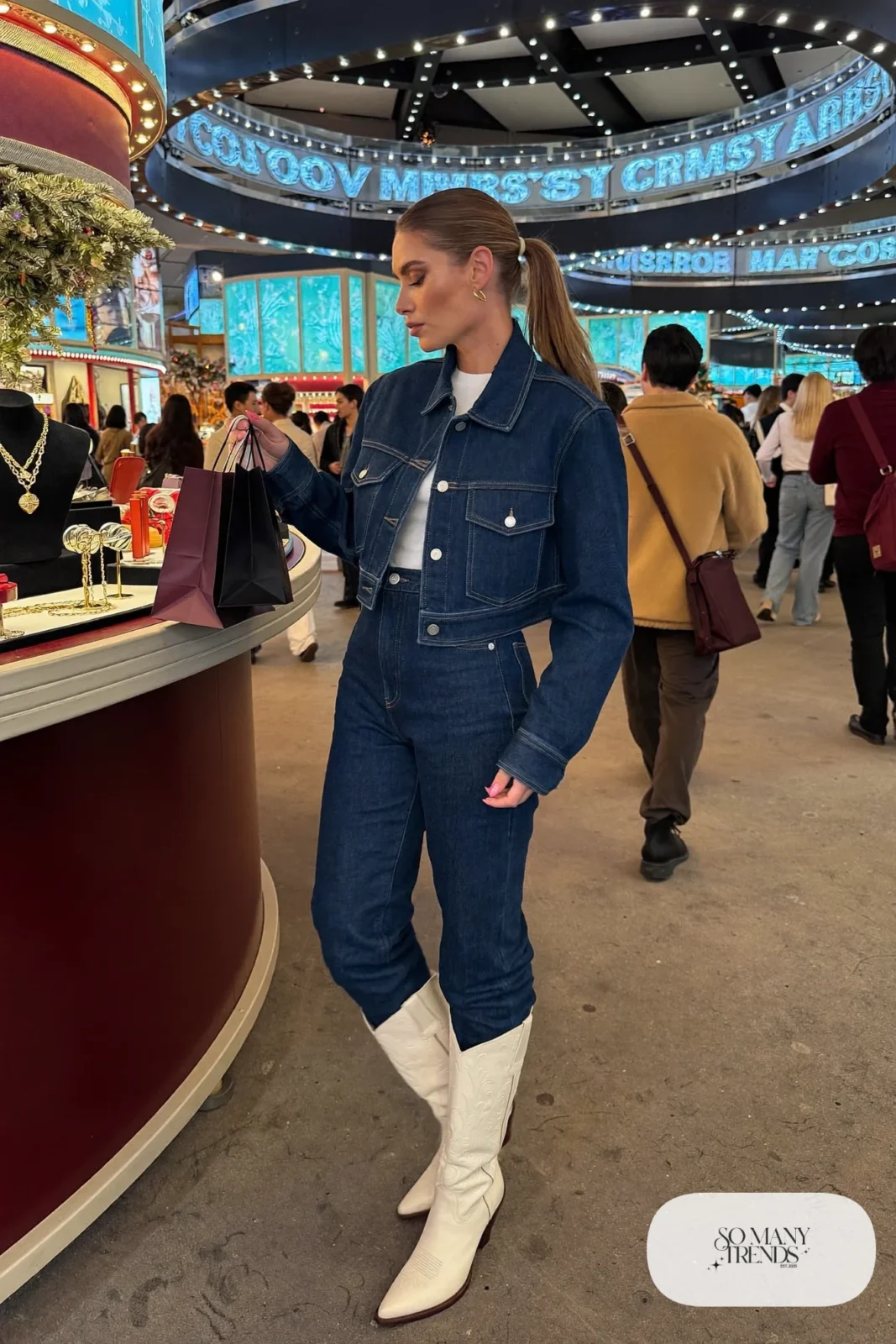 Woman in ink blue denim jacket and jeans set, white tee and cream boots, NFR outfit 28