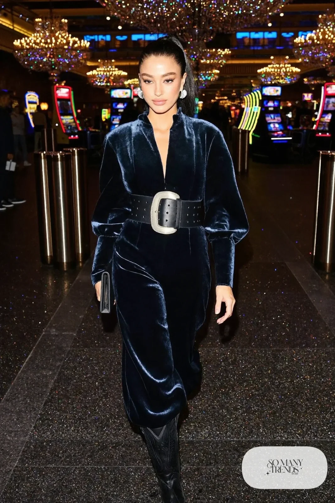 Woman in black velvet wide-leg jumpsuit, silver buckle belt and black boots, NFR outfit 30