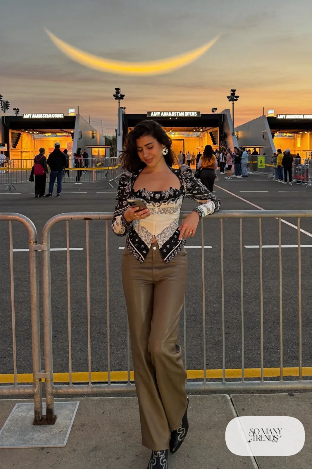 Woman in taupe faux leather straight pants, black bandana print top and black boots, outfit 6