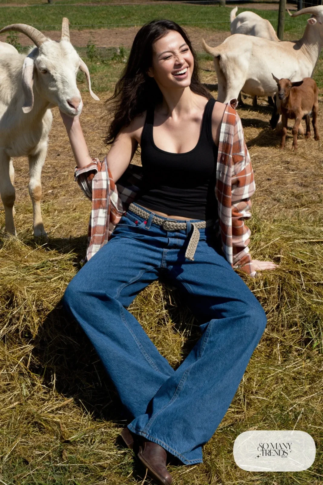 Woman in rust plaid flannel tied at the waist, black tank, wide-leg jeans and brown boots, outfit 14