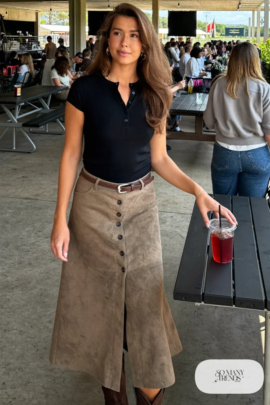 Woman in taupe suede button-front midi skirt, black knit tee and brown boots, outfit 15