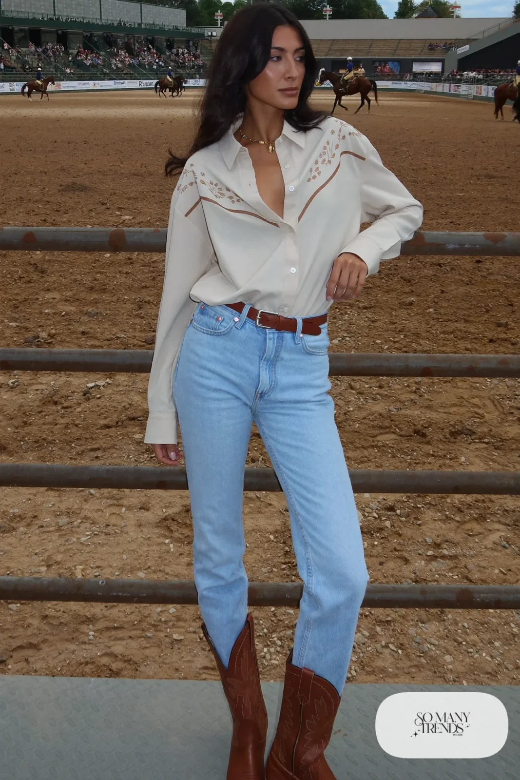 Woman in cream embroidered western shirt, light jeans, leather belt and brown boots, outfit 23