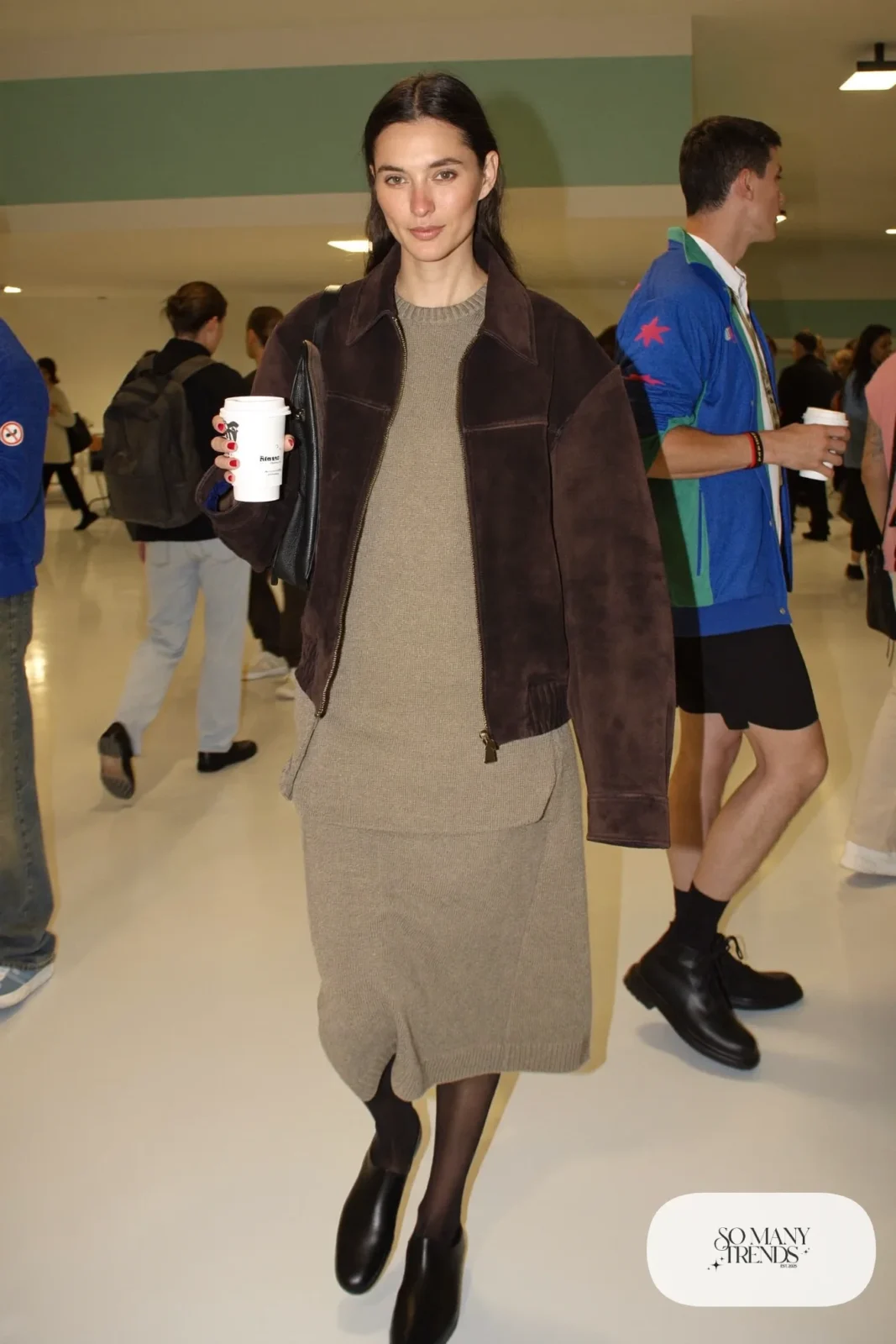 Woman in an oatmeal knit sweater and maxi skirt set with an espresso suede jacket and flat black boots, basketball game outfit 15
