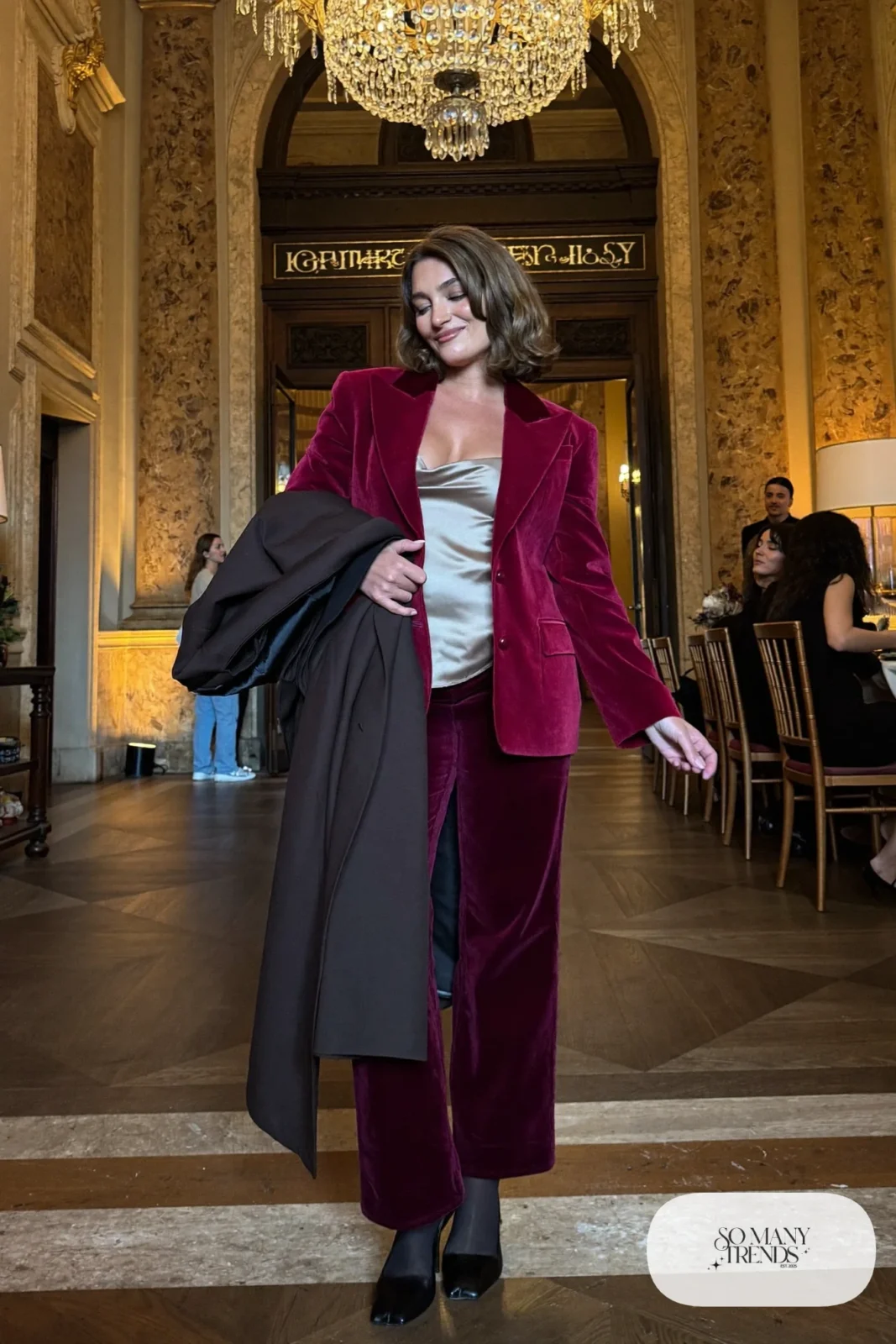 burgundy velvet blazer and straight pants suit, champagne silk camisole, black closed-toe heels, long coat, winter wedding guest outfit 21