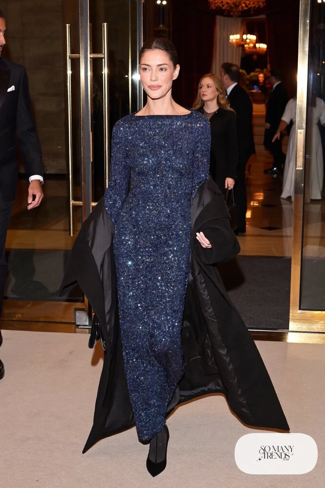 midnight blue sequin long-sleeve floor-length gown, long black coat, black satin pumps, small black bag, winter wedding guest outfit 30