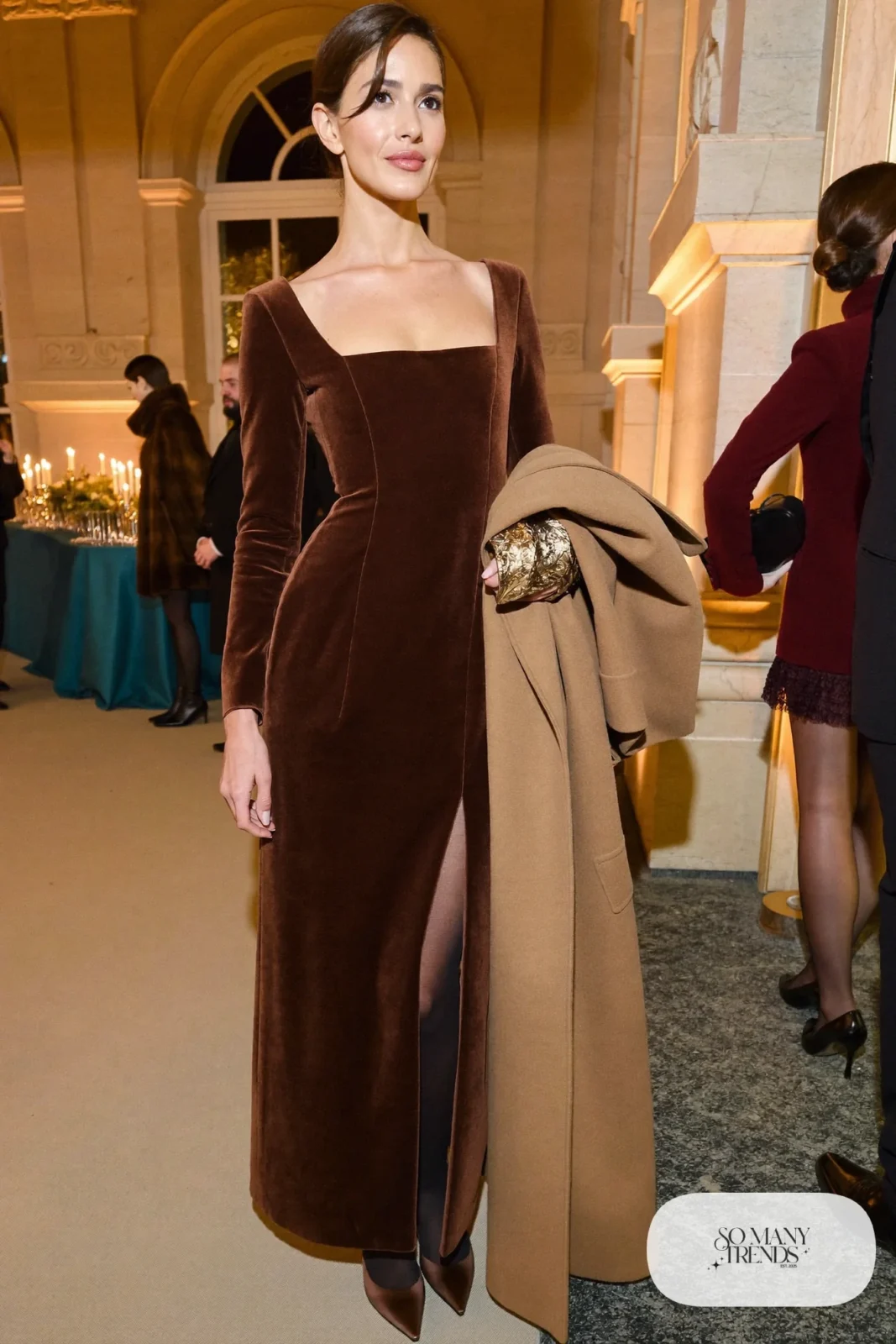 chocolate brown velvet long-sleeve floor-length gown, gold cuff, closed-toe satin pumps, long camel coat, winter wedding guest outfit 33