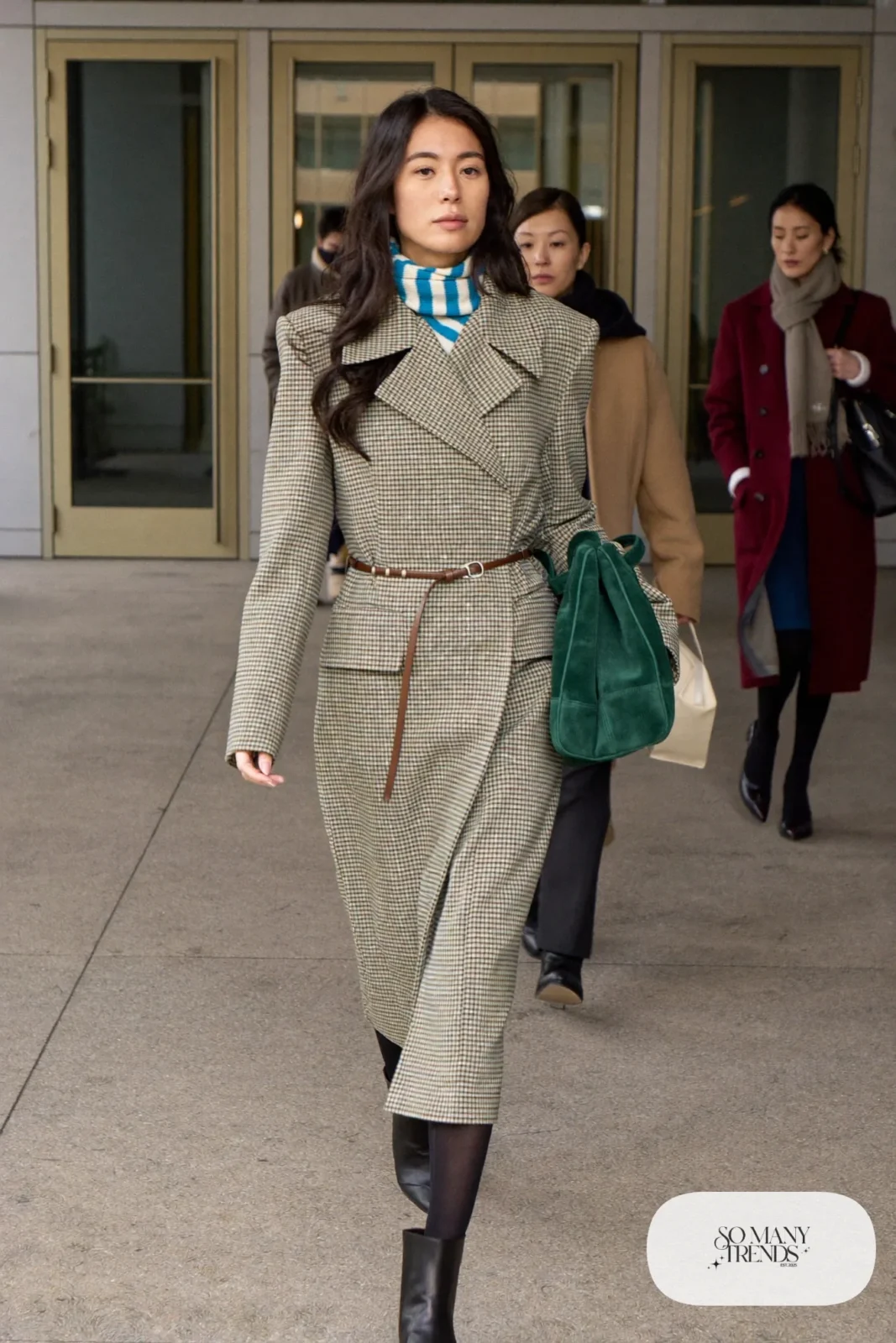 long olive green checked double-breasted coat belted at the waist with black pointed boots and green suede bag, interview outfit 5