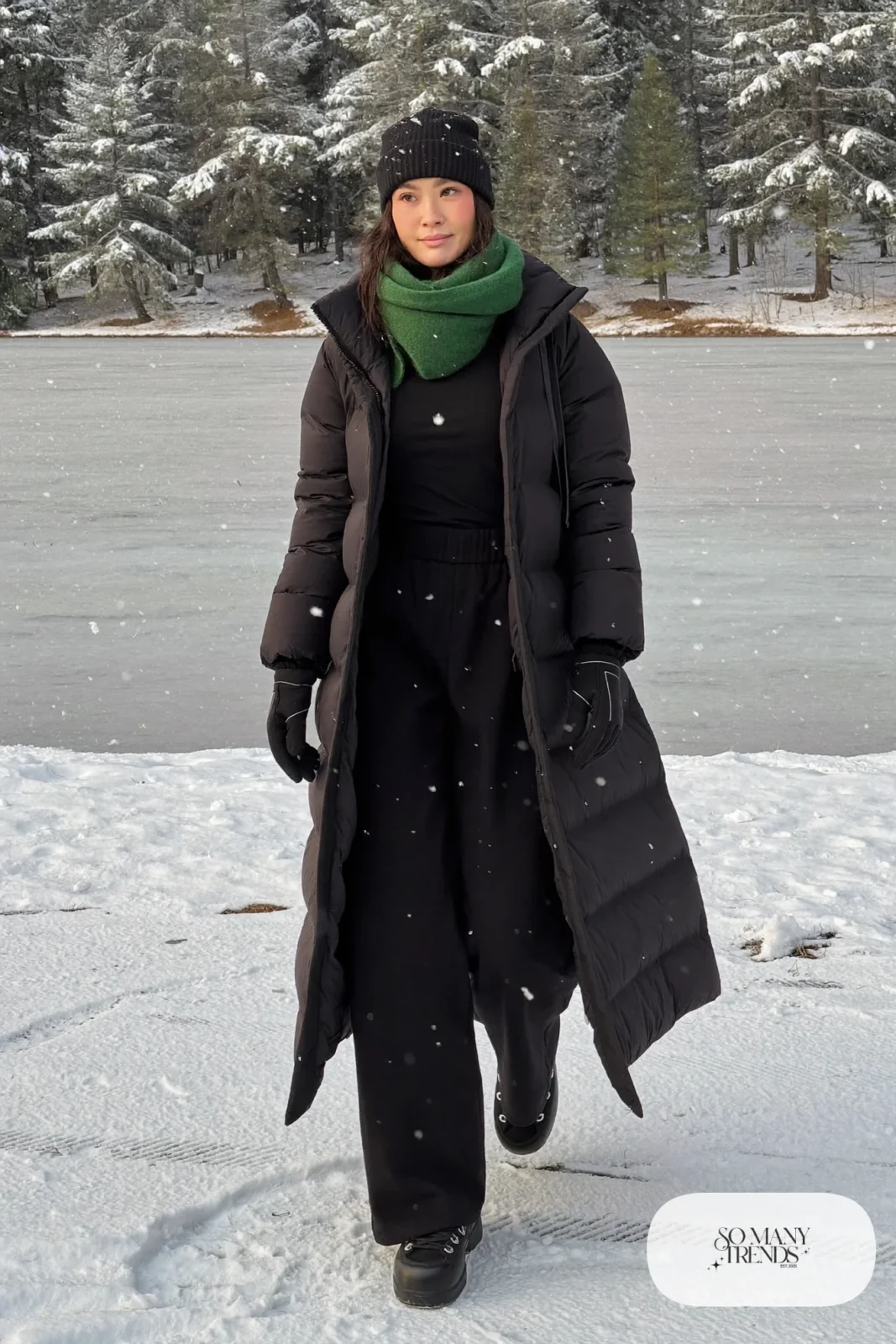 Woman in a shin-length black down coat, emerald wool scarf, black wool pants and snow boots in a Hokkaido snowfield, outfit 25