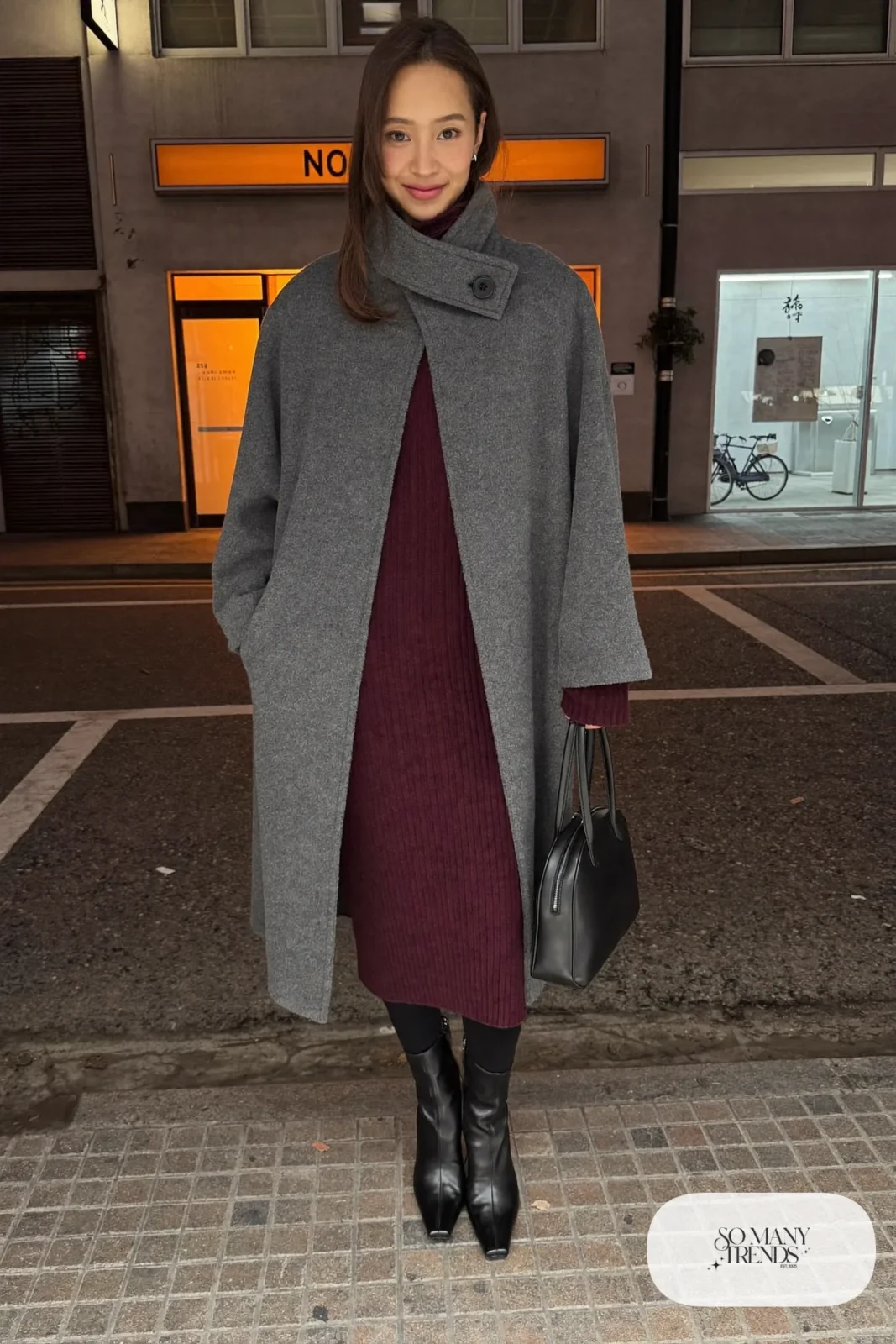 Woman in a gray wool cape over a burgundy knit midi dress with black pointed boots and a black bag at a Tokyo restaurant, outfit 29