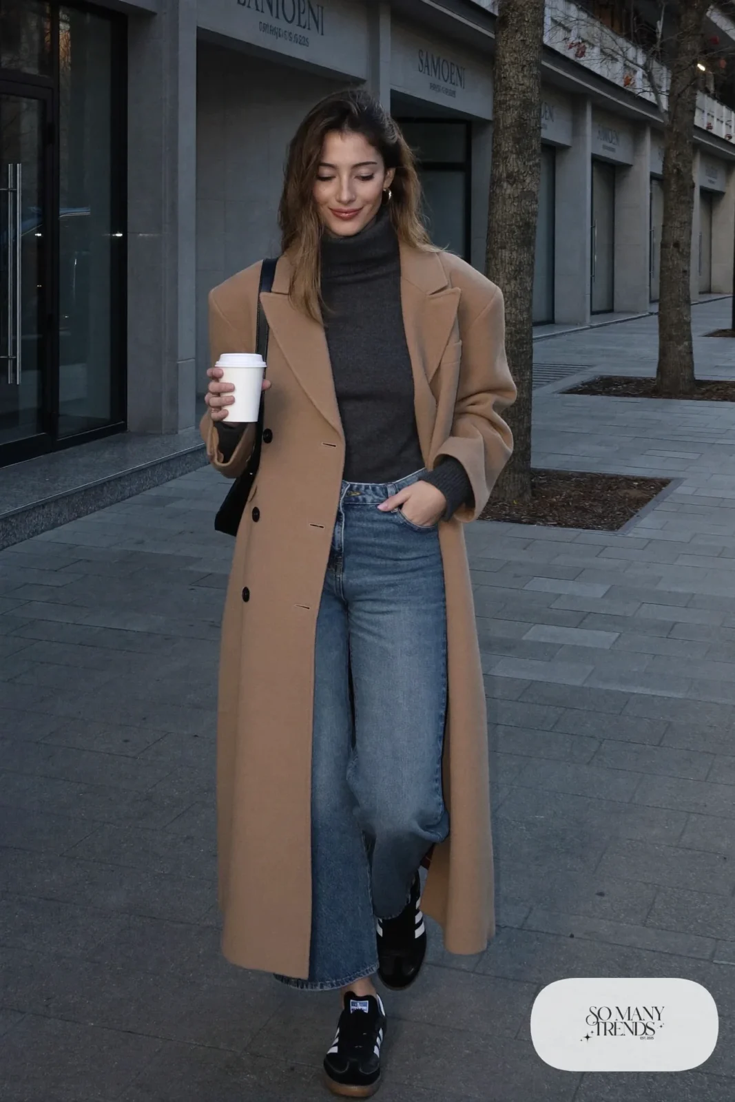 Camel long wool coat, charcoal turtleneck sweater, washed wide-leg jeans and black Adidas Samba sneakers, outfit 1