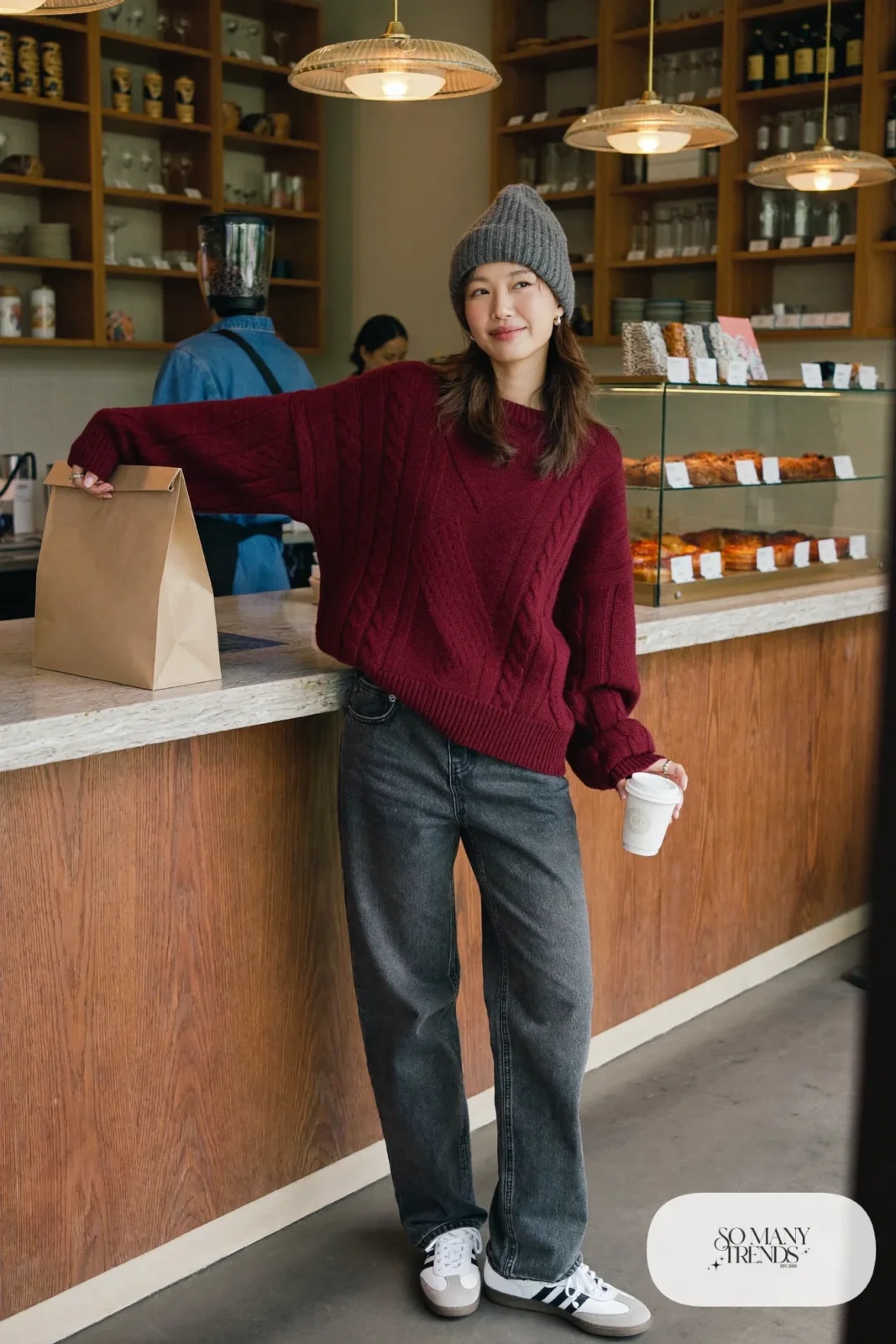 Burgundy cable-knit sweater, charcoal barrel-leg jeans and white Adidas Samba sneakers with gum sole, outfit 2