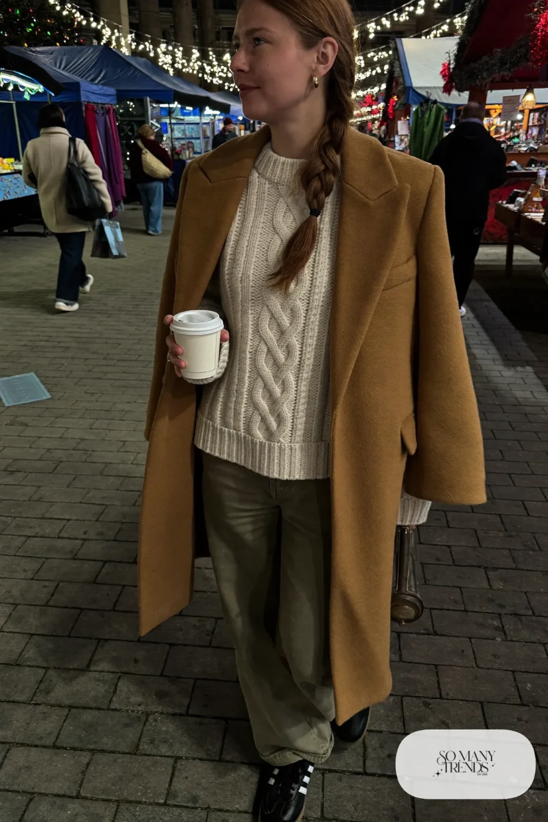 Cream cable-knit sweater, olive wide-leg cargo pants, camel coat and black Adidas Samba sneakers, outfit 29