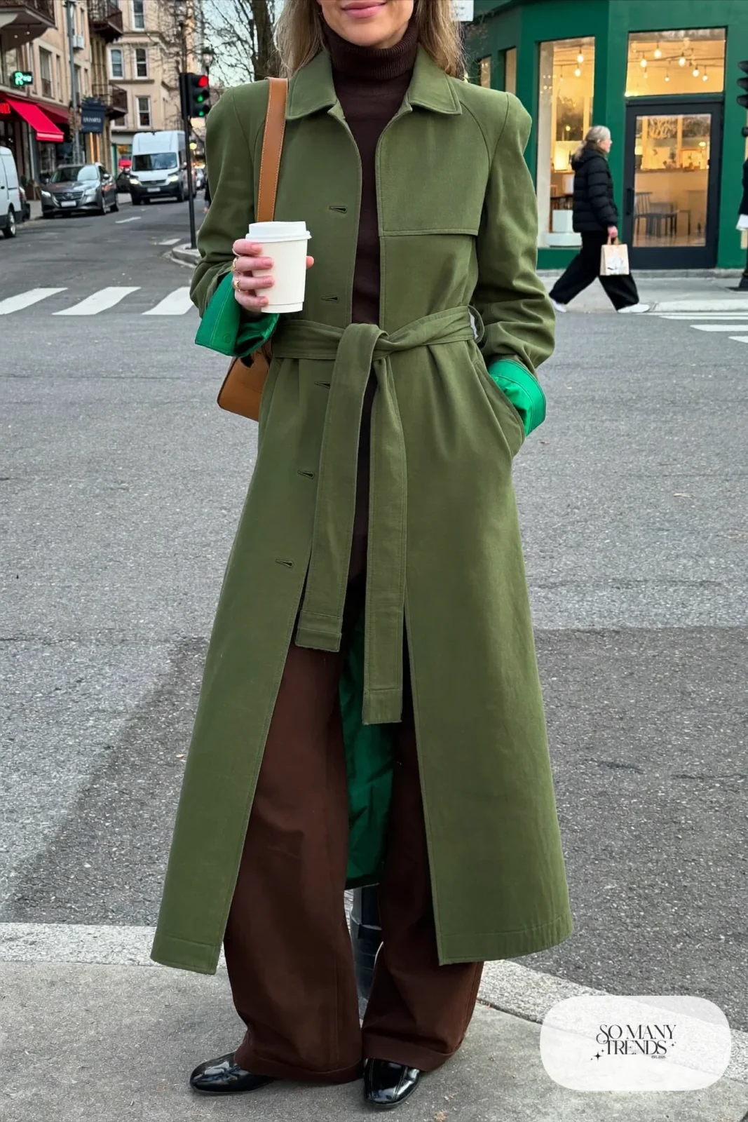 Woman in olive trench coat, chocolate turtleneck, brown wide-leg pants and loafers, outfit 1