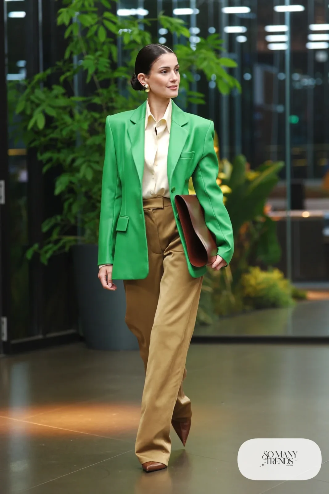 Woman in emerald blazer, cream shell, tan wide-leg pants and brown pointed flats, outfit 4