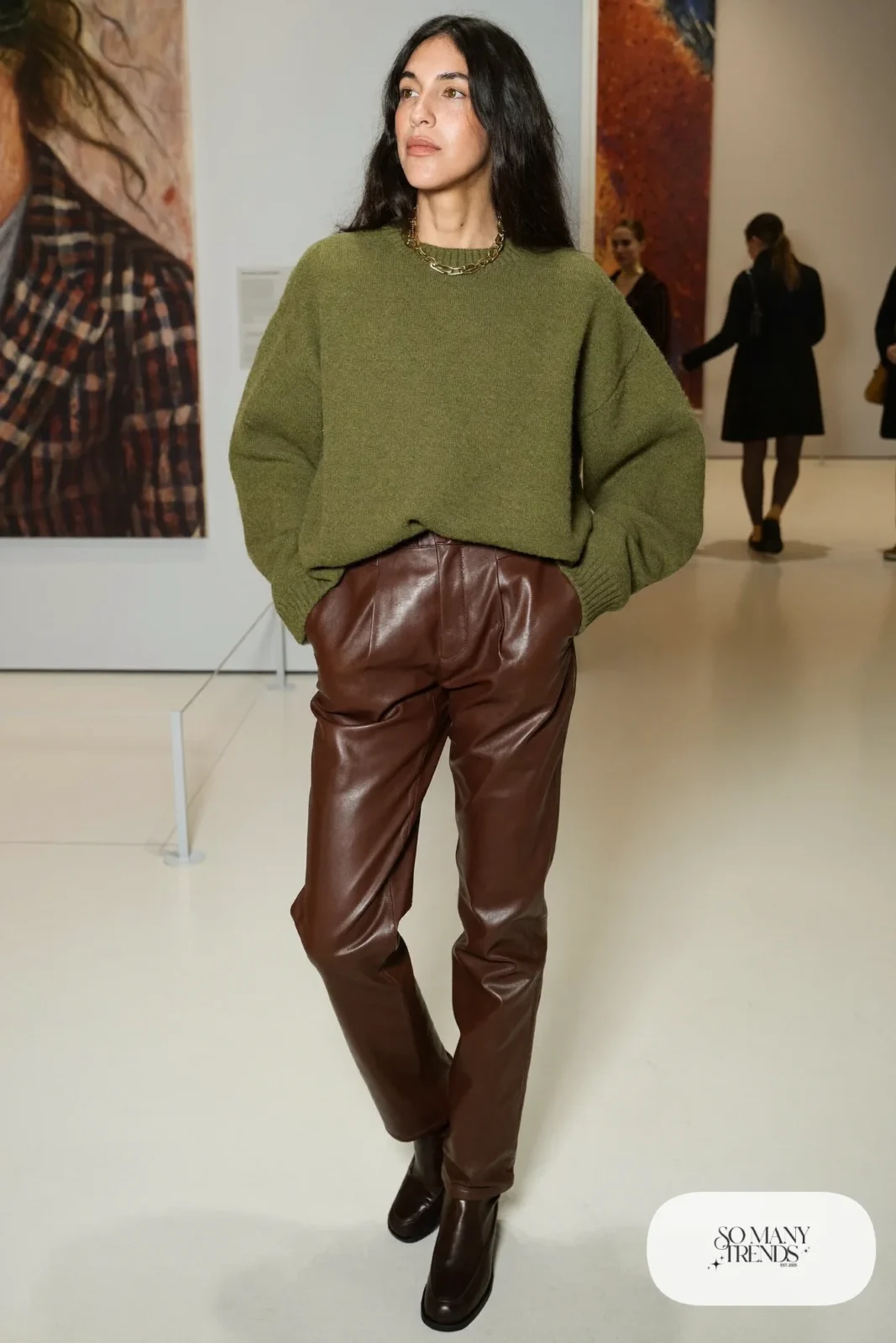 Woman in olive sweater, chocolate faux leather straight pants and dark ankle boots, outfit 9