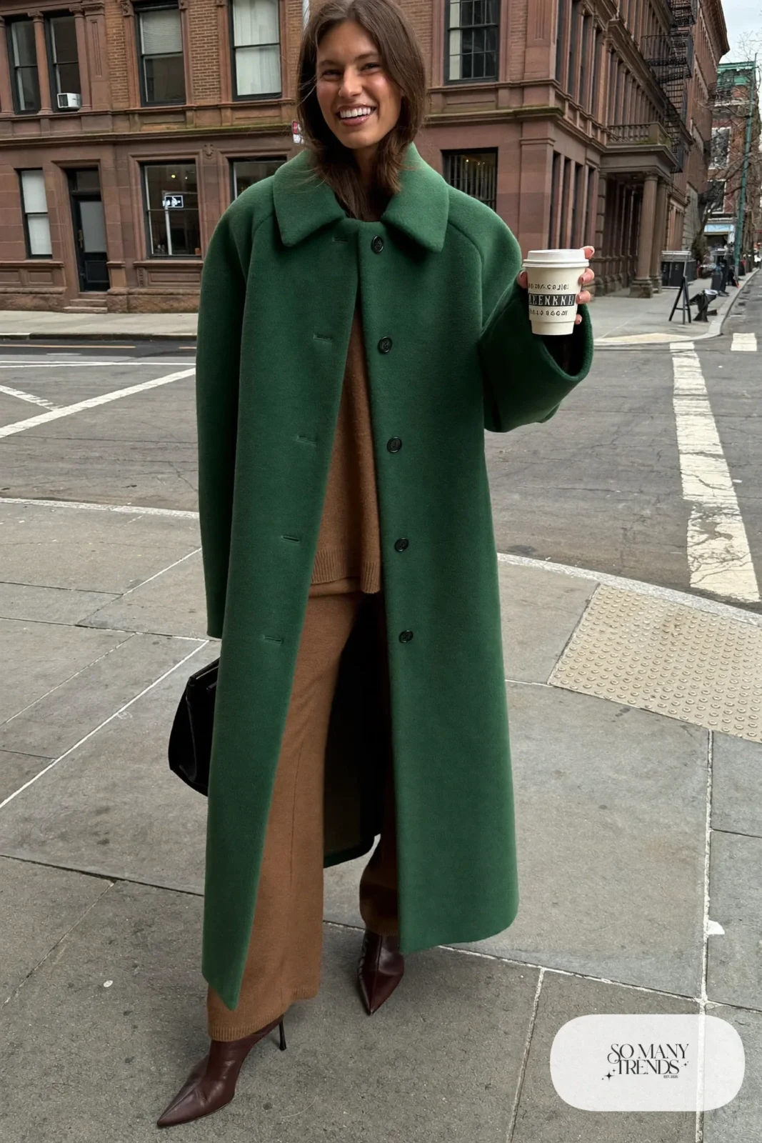 Woman in bottle green wool coat, camel knit sweater and pants set, and dark brown boots, outfit 18
