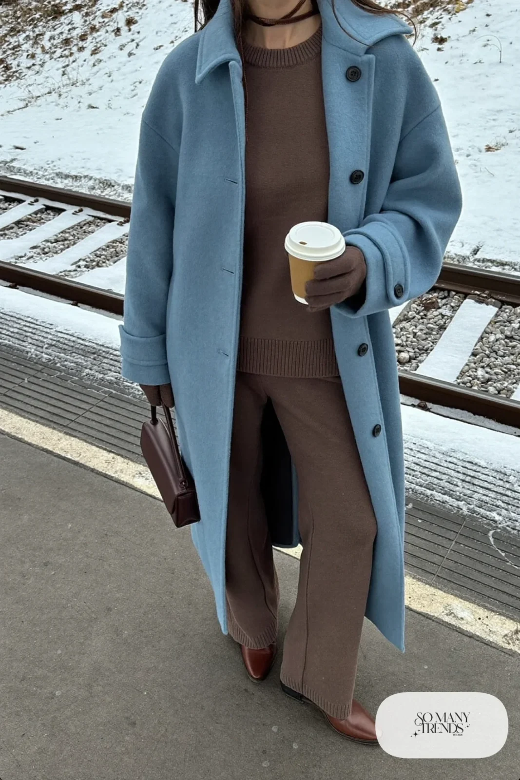 Long baby blue wool coat over a chocolate brown knit sweater and matching knit pants with brown ankle boots, outfit 10