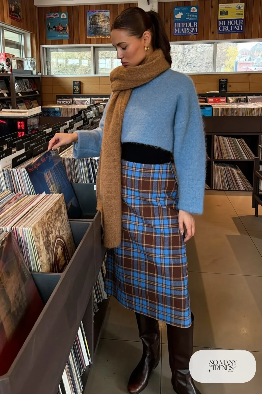 Brown and blue plaid wool midi skirt with a cropped sky blue knit sweater and tall dark brown leather boots, outfit 17