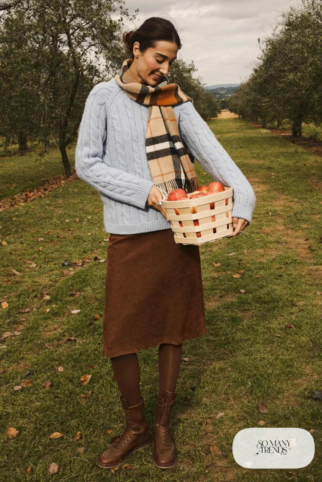 Baby blue cable knit sweater with a brown corduroy midi skirt, tights and brown lace-up boots, outfit 26