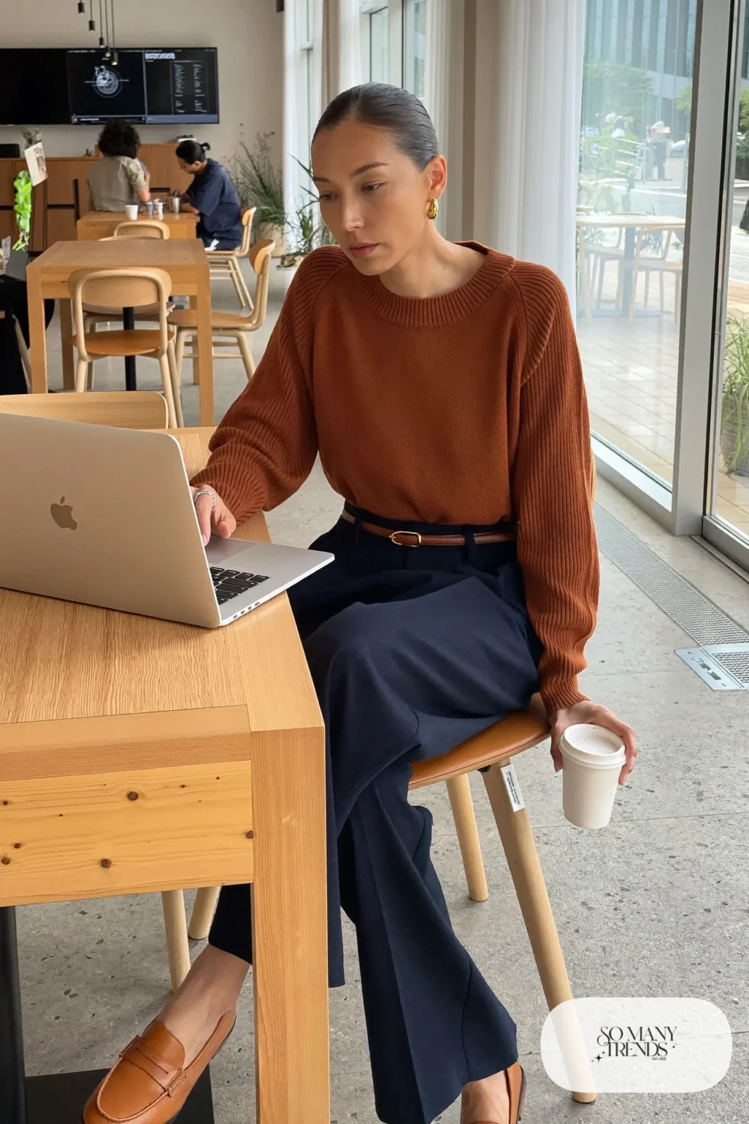 Woman in a cognac ribbed sweater, navy wide-leg pants, brown belt and tan loafers, outfit 8