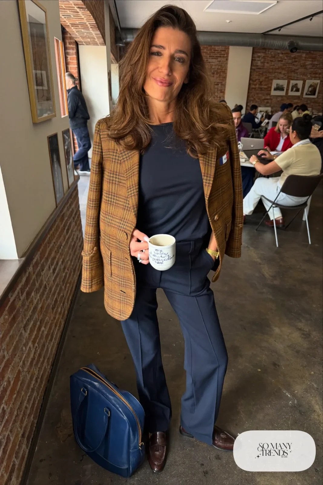 Woman in a brown plaid blazer, navy tee, navy straight pants and brown leather loafers, outfit 22