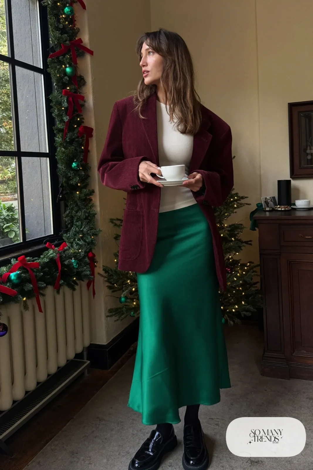 Woman in burgundy corduroy blazer, forest green slip midi skirt, cream tee, black tights and black loafers, outfit 12