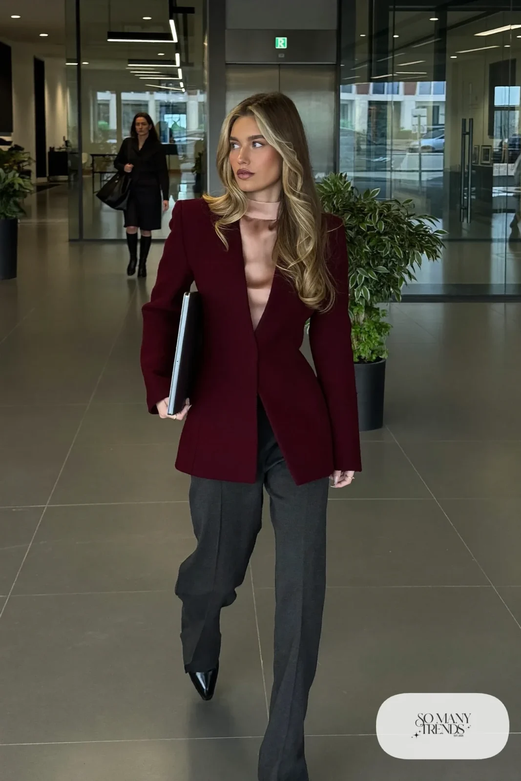 Woman in burgundy longline blazer, blush pink silk camisole, charcoal straight-leg pants and black pointed loafers, outfit 2