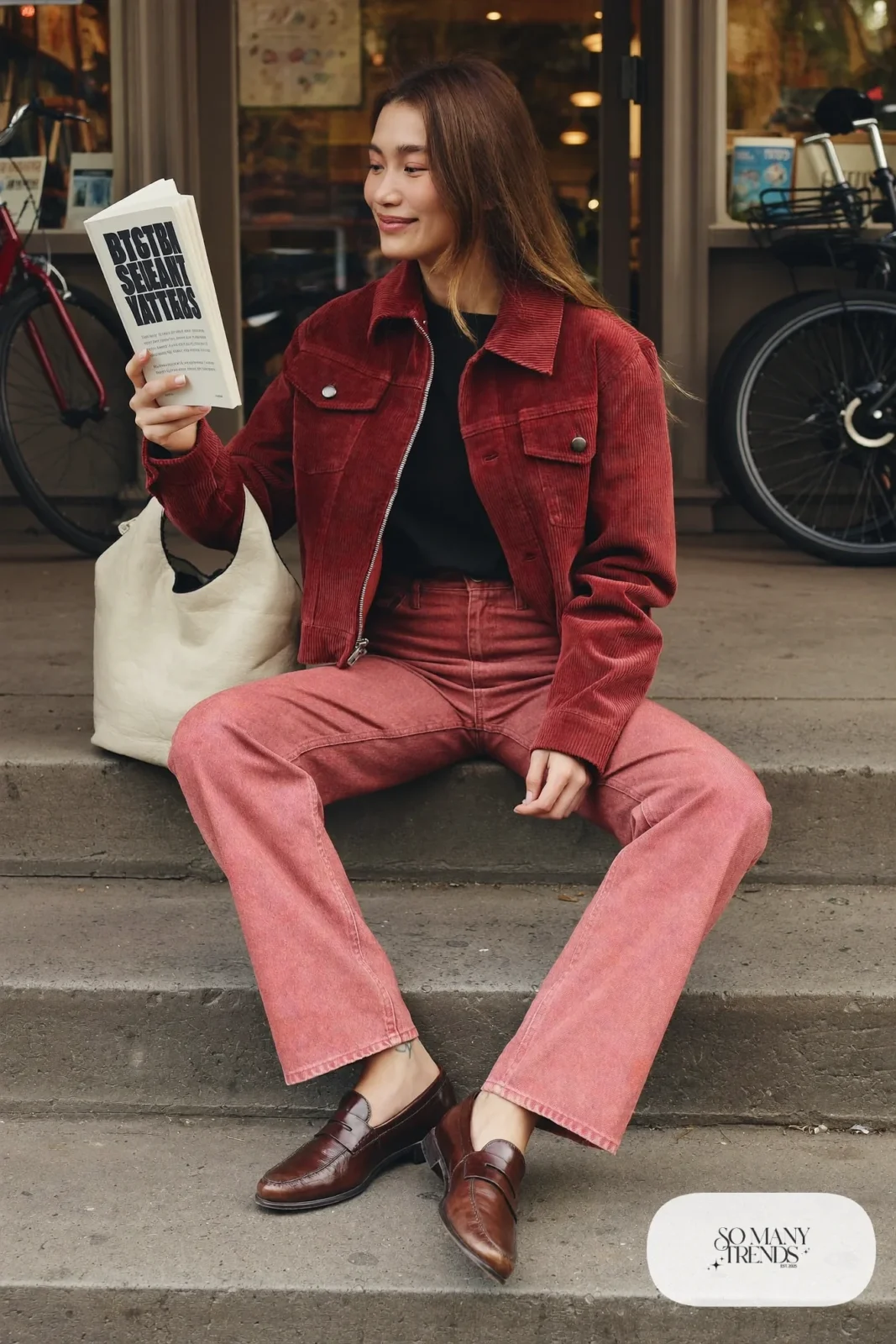 Woman in burgundy corduroy jacket, black tee, dusty-rose straight jeans and brown leather loafers, outfit 6