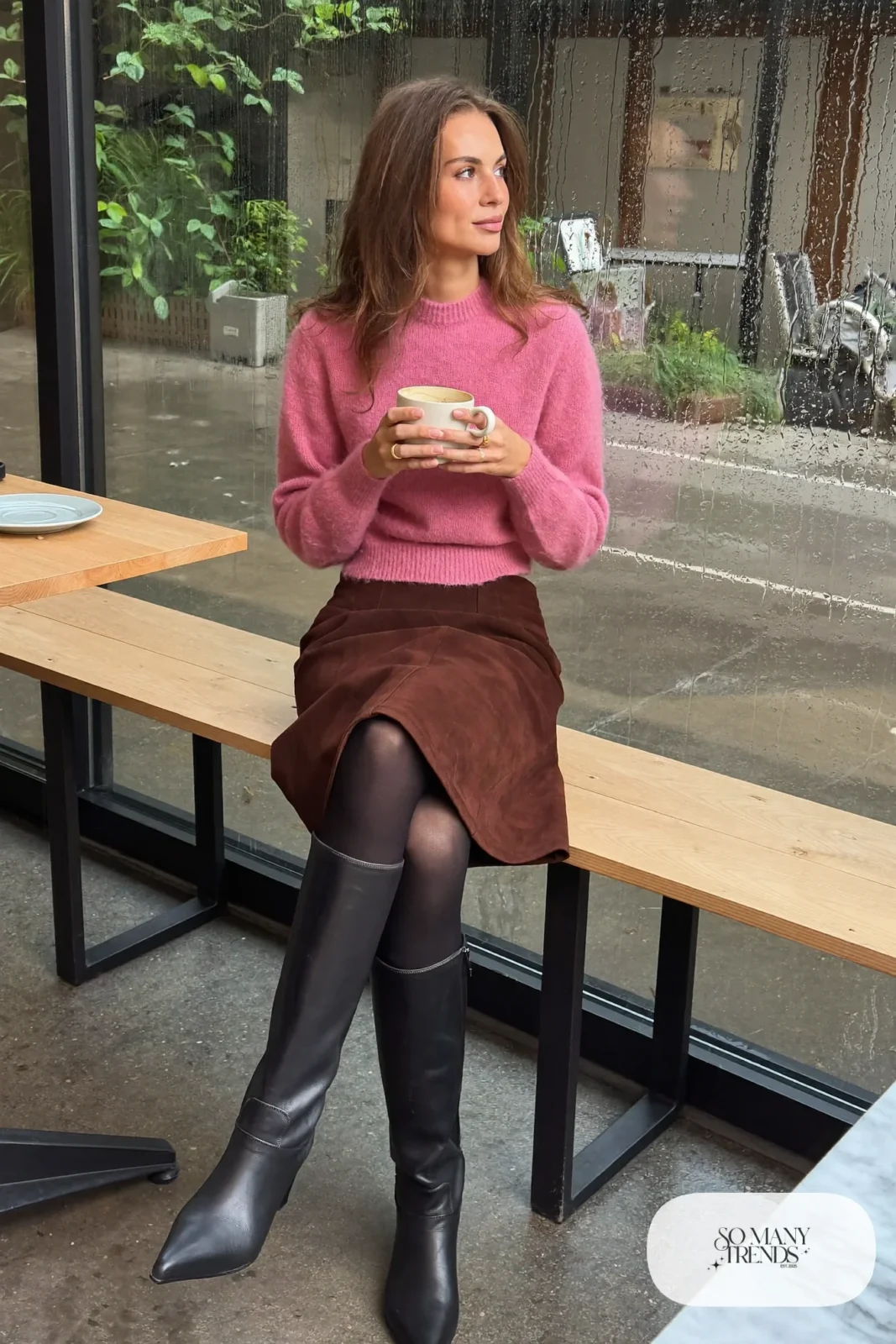 Woman in pink fuzzy mohair sweater, burgundy faux suede A-line skirt, opaque black tights and black knee-high boots, outfit 12