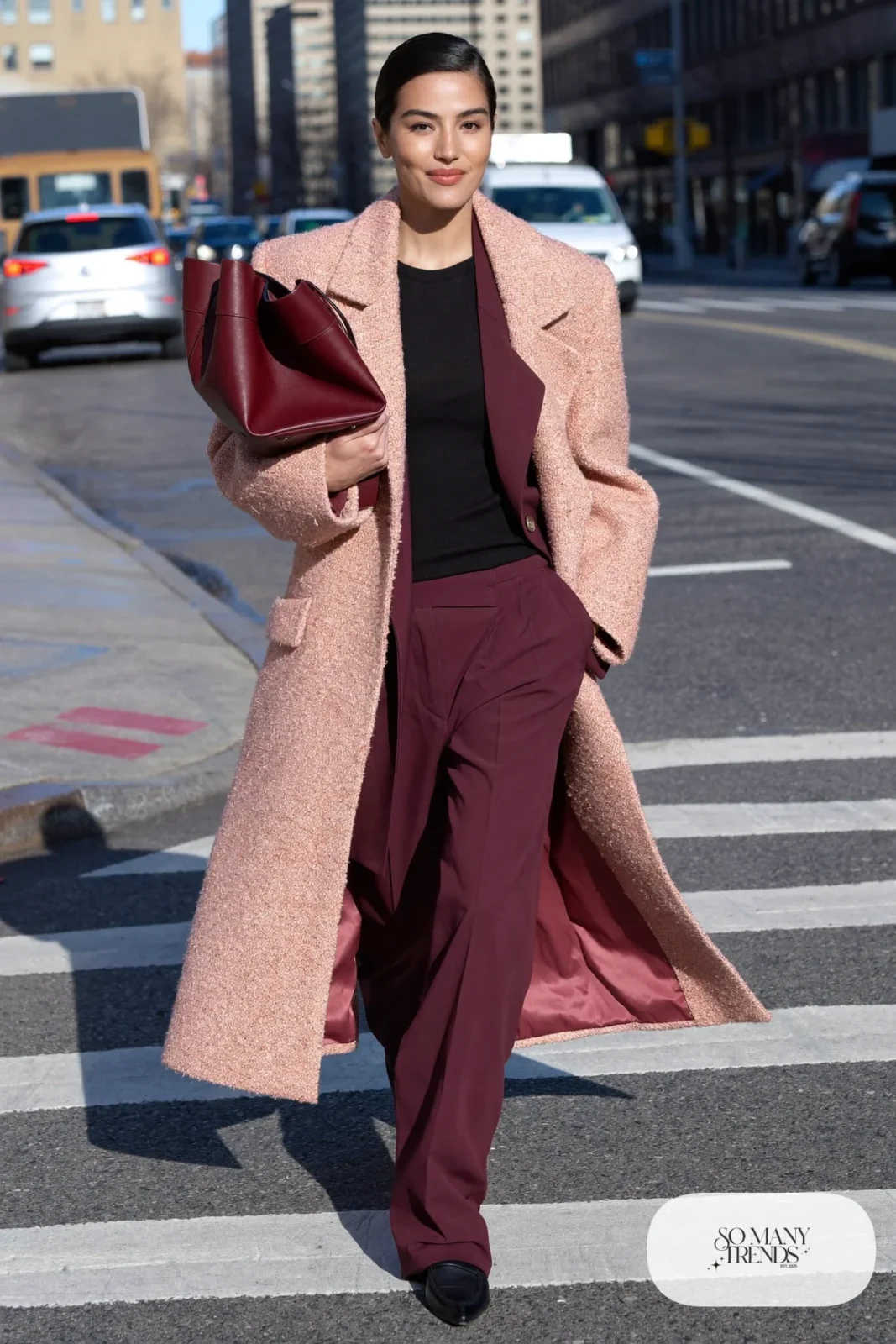 Woman in long pink wool coat over burgundy blazer and matching wide-leg pants with black knit and black loafers, outfit 13