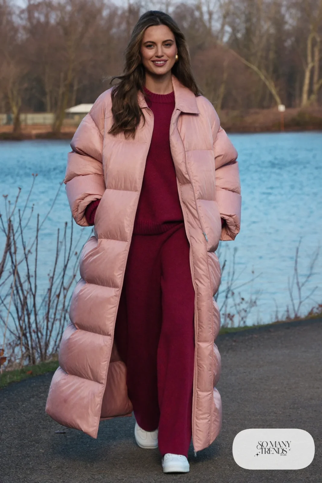 Woman in long pink padded coat, wine knit sweater and pants set and white sneakers, outfit 29