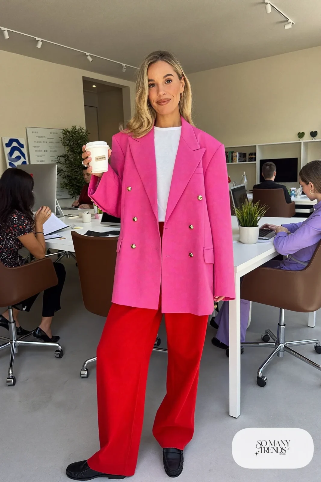 Woman in a hot pink double-breasted blazer, white tee, red wide-leg pants and black loafers, outfit 2