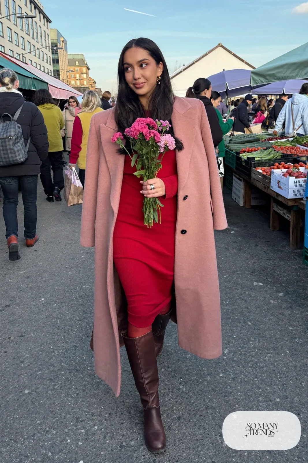 Woman in a cherry red ribbed knit midi dress under a long blush pink wool coat with sheer tights and tall brown boots, outfit 8